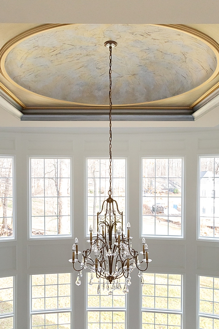 Natural light from huge windows and a chandelier for dull days and nightime.