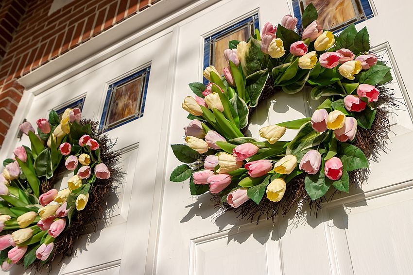 pretty spring wreaths on a double front door.